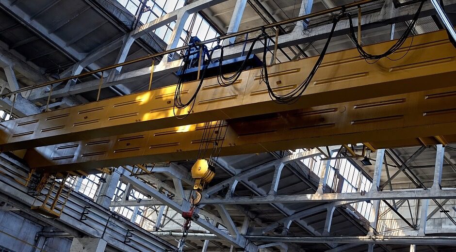Overhead bridge crane spanning an industrial manufacturing facility Overhead bridge crane spanning an industrial manufacturing facility