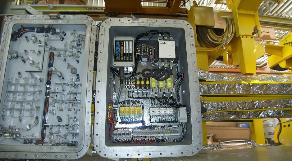 Interior of an open overhead crane control enclosure showing electrical components, wiring, and contactors built by Ace World Companies Interior of an open overhead crane control enclosure showing electrical components, wiring, and contactors built by Ace World Companies