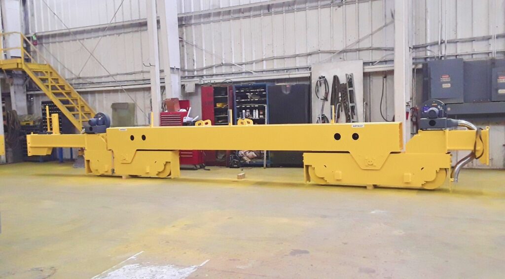 Single girder crane assembly with end trucks and drive motors on shop floor
